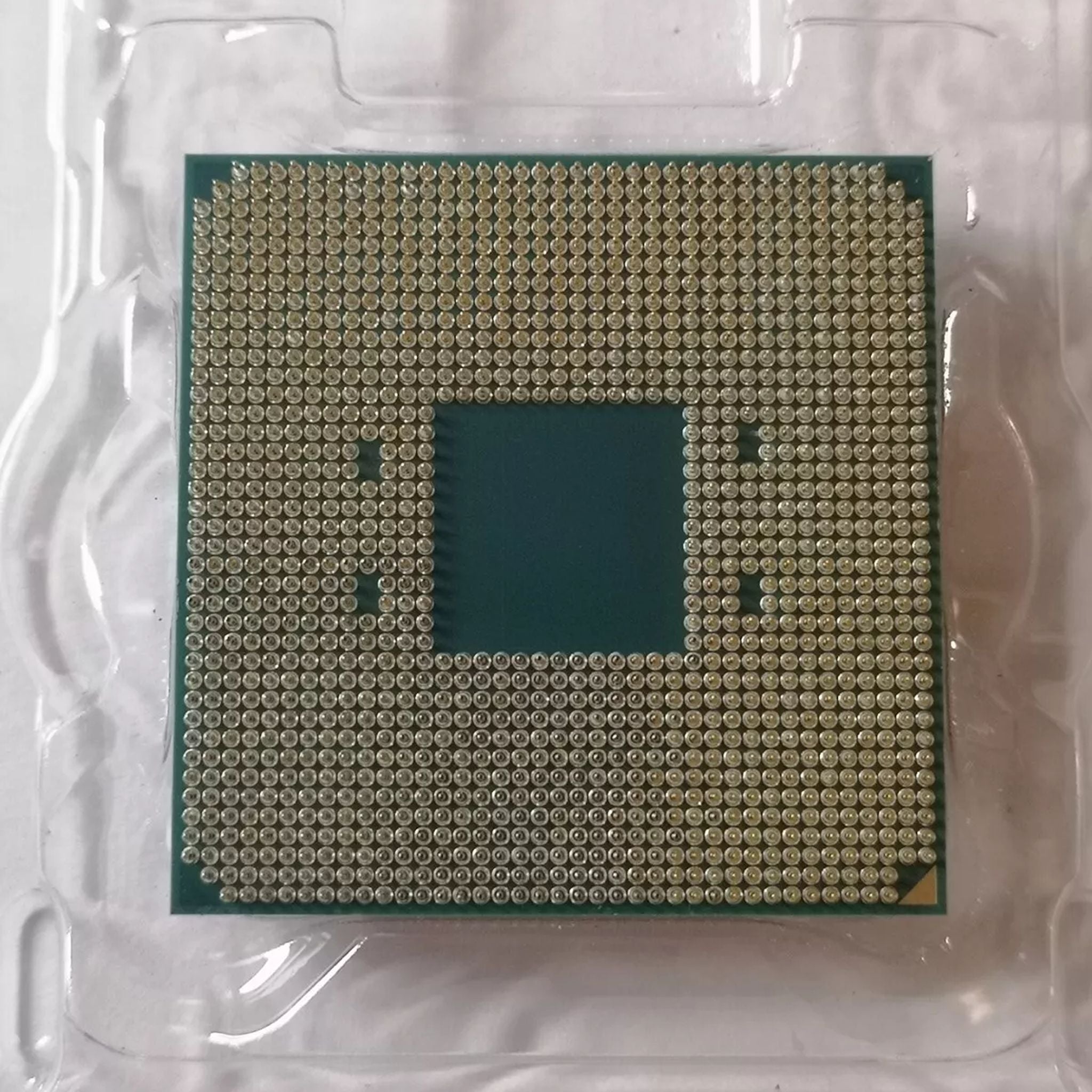 AMD Ryzen 5 3400G processor with gold pin array on green substrate