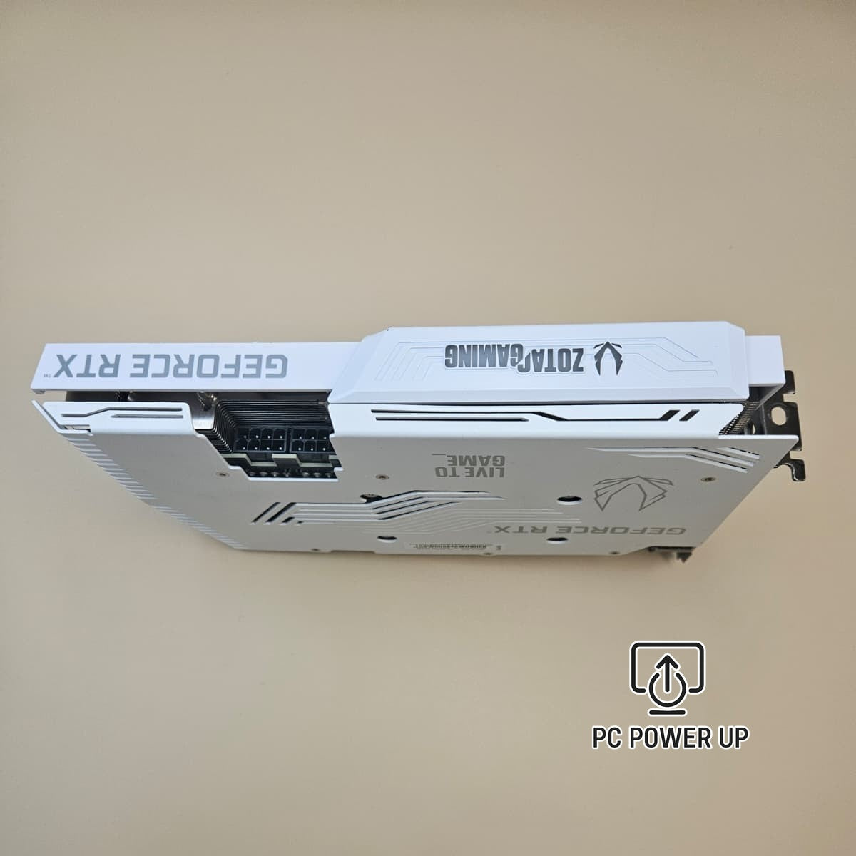 White ZOTAC graphics card backplate with cutouts and PCIe bracket