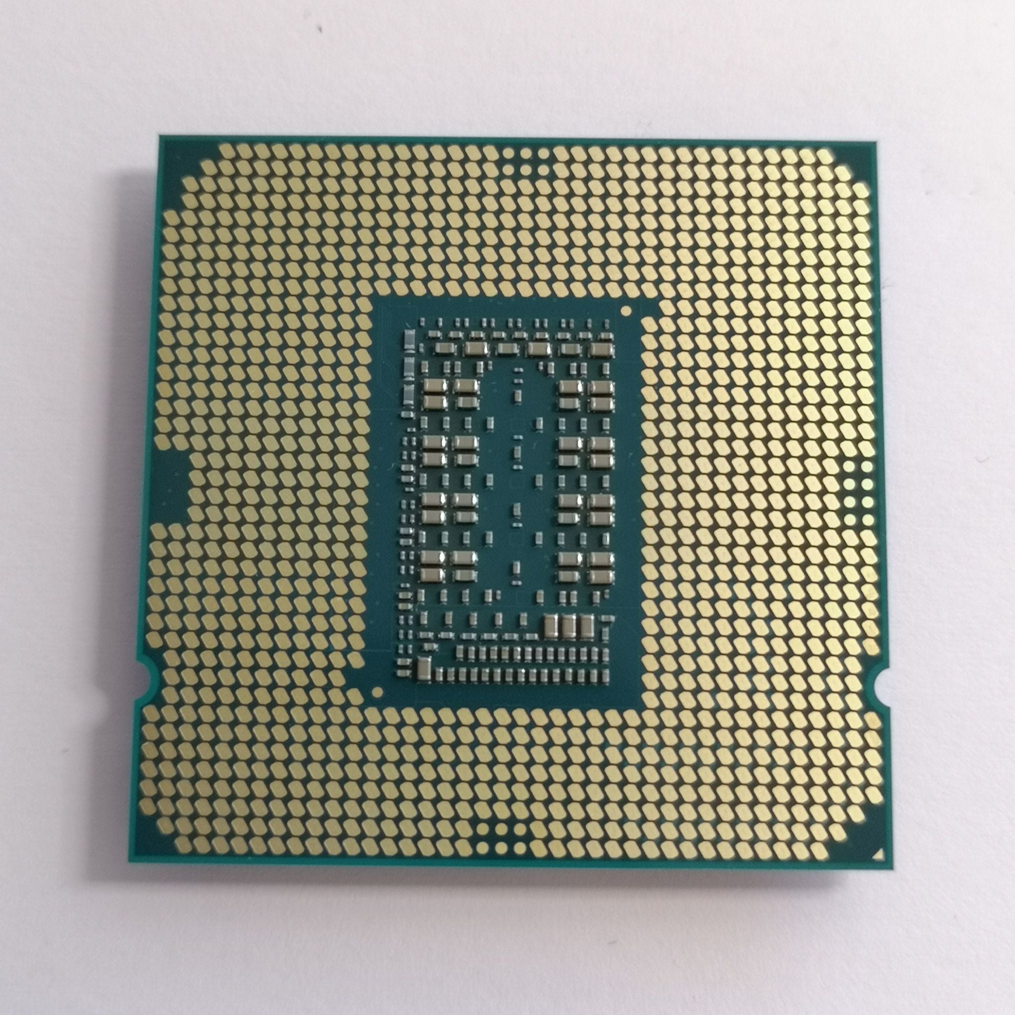 Intel Core i5-11600K CPU chip with gold LGA pin grid, green package
